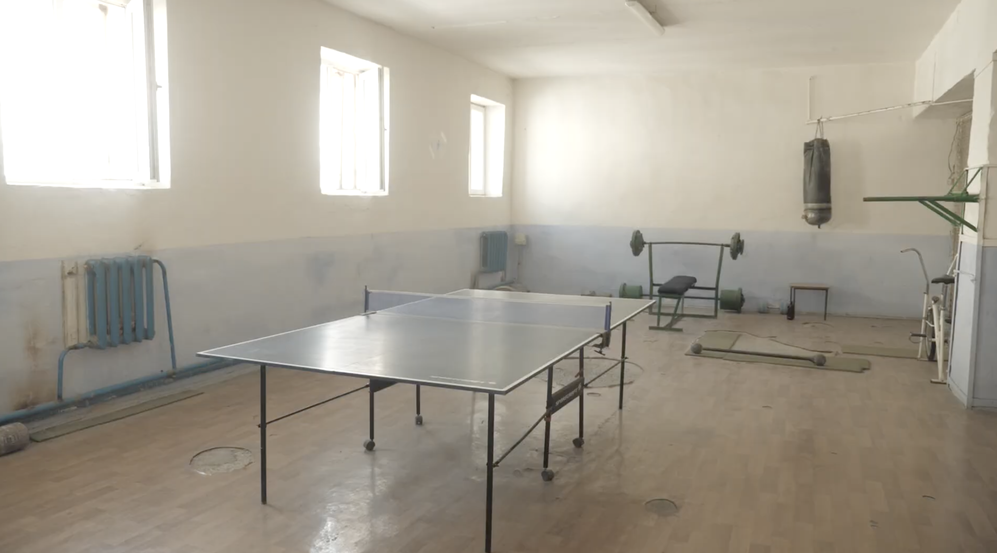 Moldova Gymnasium before renovation showing basic facilities with ping pong table and exercise equipment