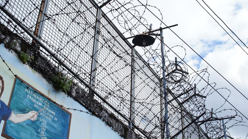 Prison fence with barbed wire