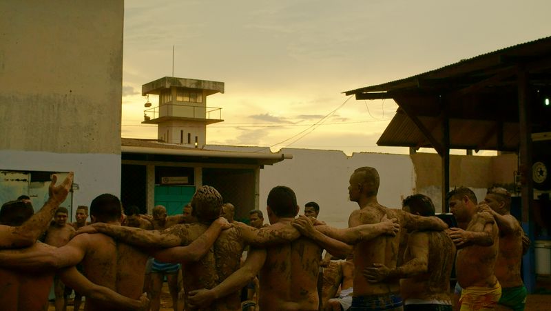 Inmates standing in solidarity circle in prison yard