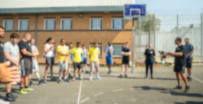 Group participating in a prison sports program on a basketball court