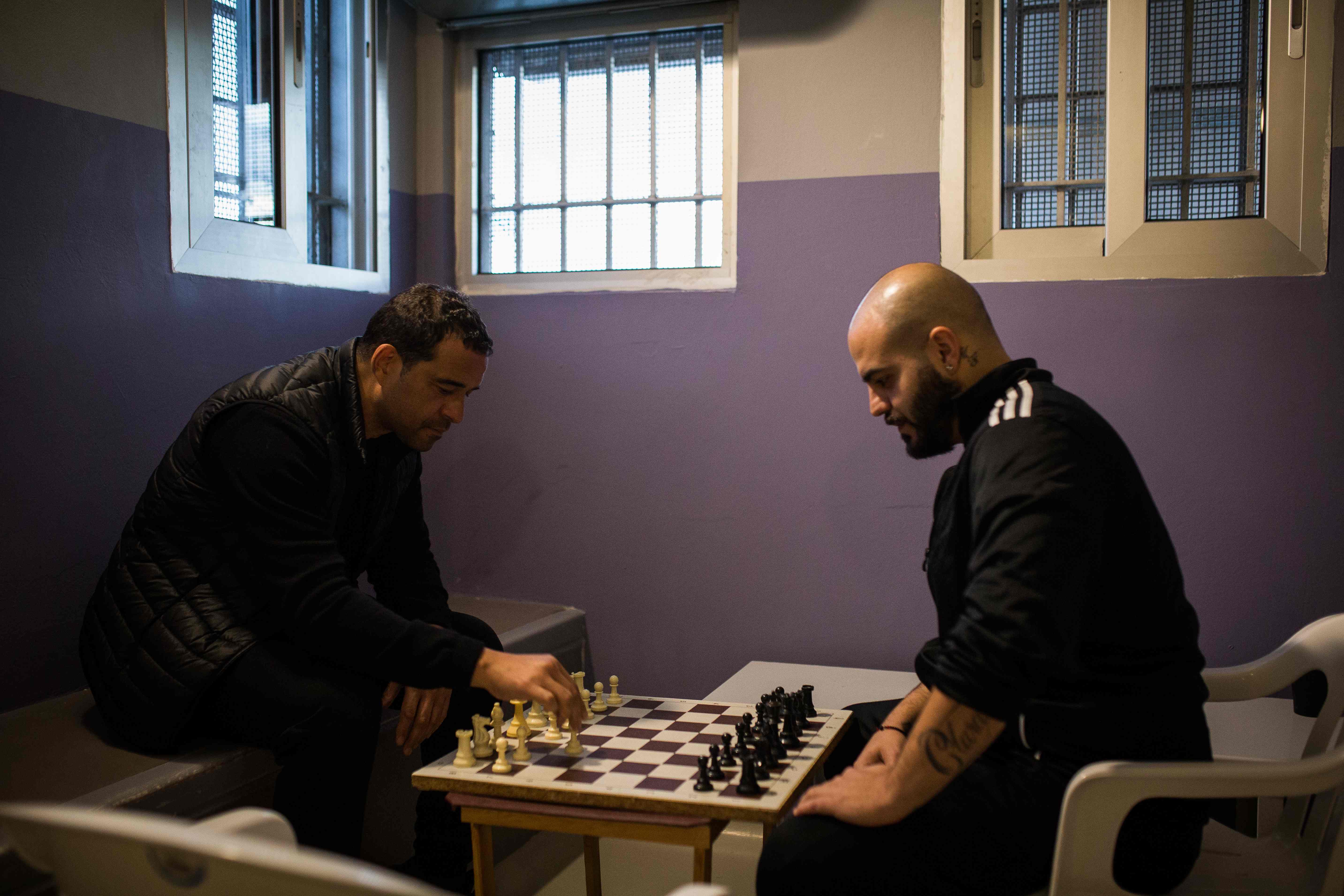 Raphael Rowe playing chess with a prisoner, showing rehabilitation through meaningful activities