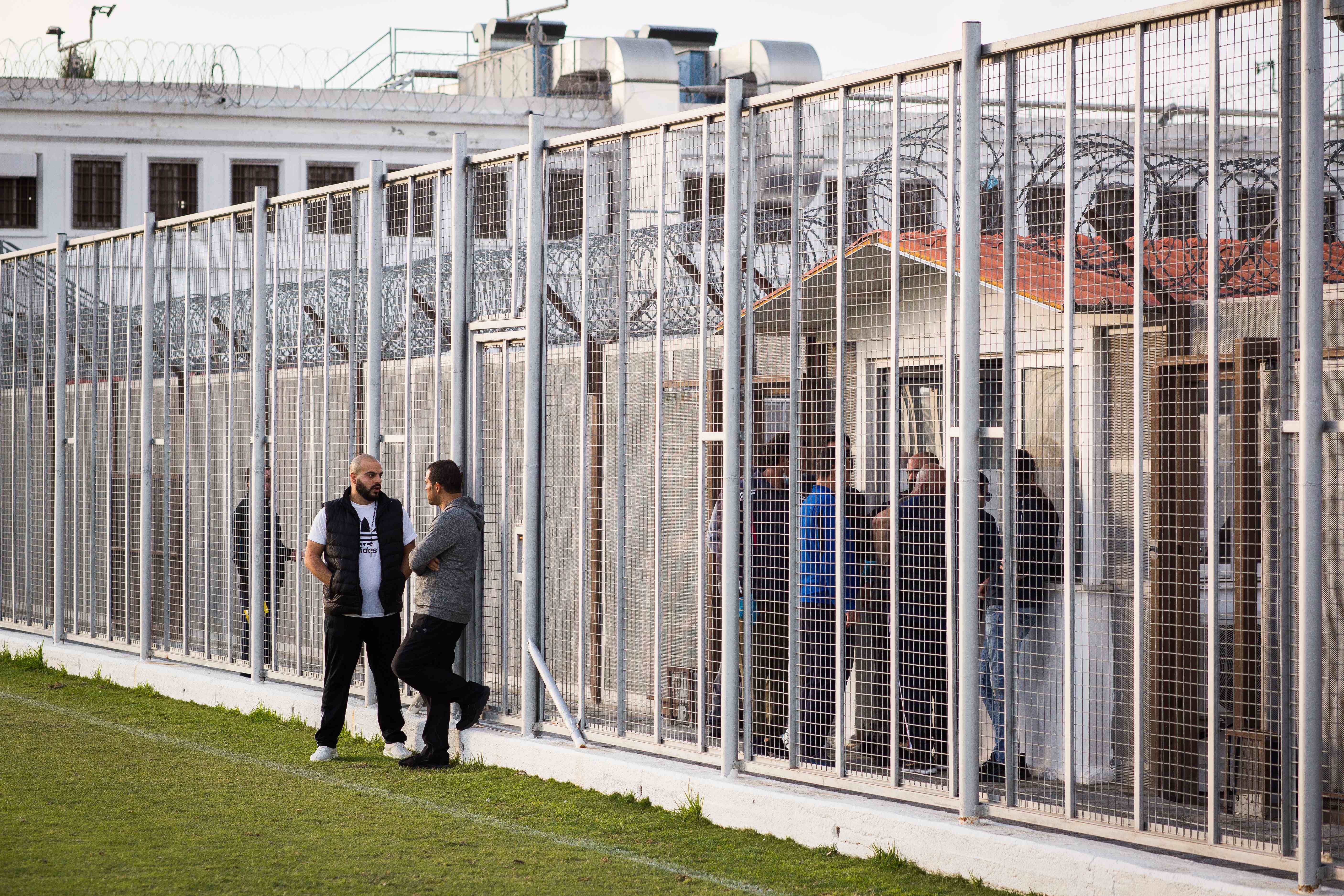 Raphael Rowe in conversation outside a prison facility, demonstrating global prison reform work