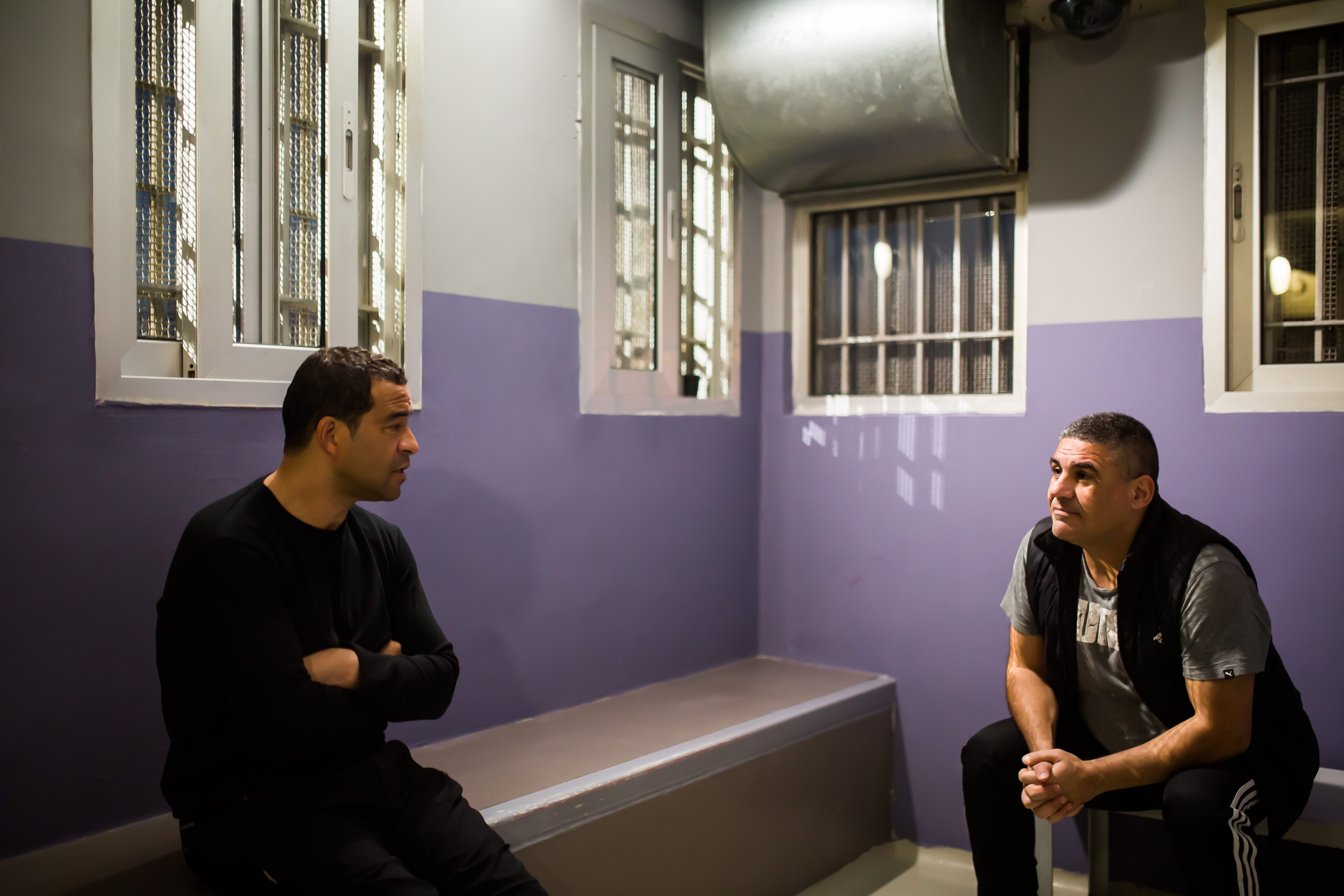 Raphael Rowe speaking with a prisoner in Cyprus